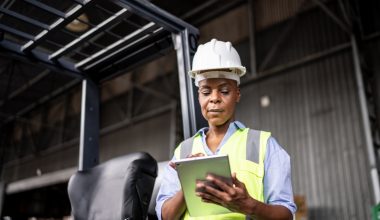 Mature woman working on a digital tablet in a warehouse