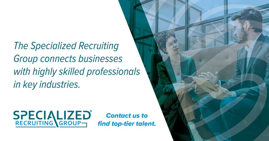 A promotional image featuring two professionals in a discussion, with text overlay detailing recruiting services by The Specialized Recruiting Group. 

Text says The Specialized Recruiting Group connects businesses with highly skilled professionals in key industries. Specialized Recruiting Group. Contact us to find top-tier talent. 