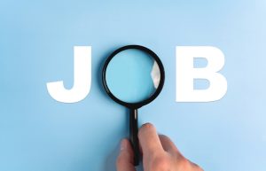 The word "JOB" with a magnifying glass over the "O" on a blue background.