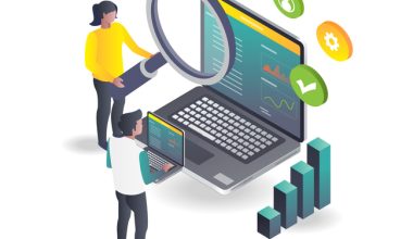 Two people analyzing charts and graphs on a large laptop screen using a magnifying glass, with icons for user, settings, and checkmark floating above.