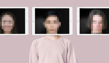 Three tablet screens displaying pixelated images positioned above a person wearing a light pink sweatshirt, set against a solid pastel background.